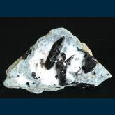 Neptunite on Natrolite